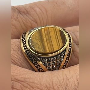 Gold stainless steel with semi-precious tiger eyes stone.